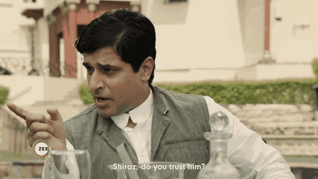 a man is talking to another man and the words shiraz do you trust him are on the screen