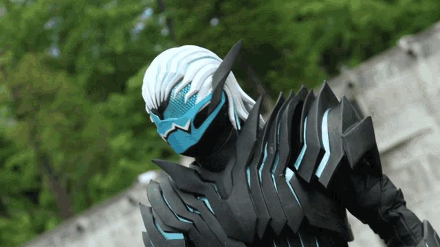 a person in a black and blue costume with a mask on