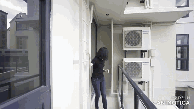 a woman stands on a balcony with panasonic air conditioners