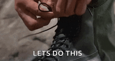 a person is tying their boots with the words `` lets do this '' written next to them .