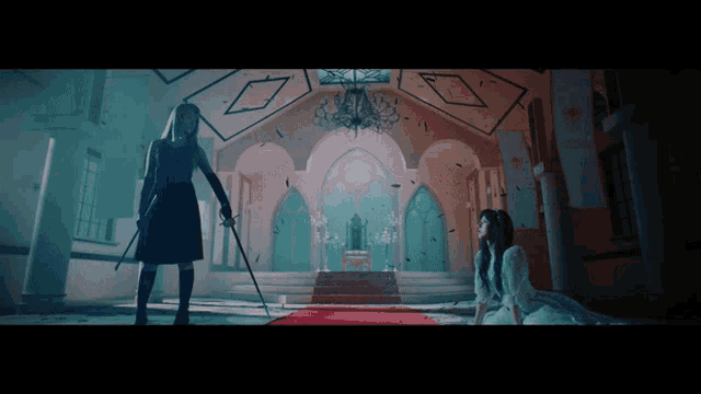 a woman in a black dress is holding a sword and a woman in a white dress is kneeling down