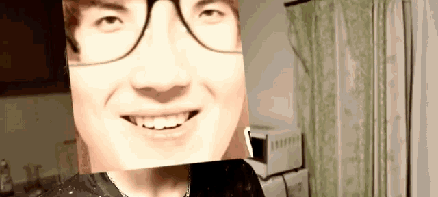 a man with glasses and a picture of his face on his face .