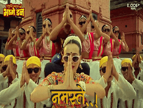 a group of people are dancing in front of a sign that says loop in nepal