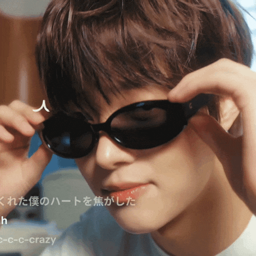a close up of a person wearing sunglasses with the words c-c-c-crazy below