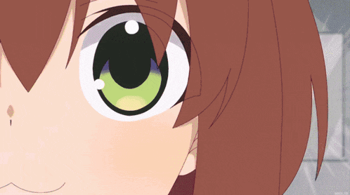 a close up of a girl 's face with green eyes and brown hair