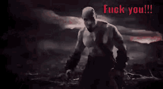 a close up of a zombie 's face with red eyes and the words `` fuck you '' written on it .