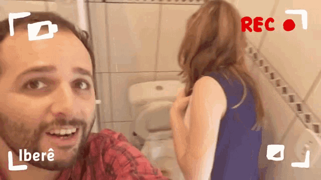 a man and a woman are taking a selfie in a bathroom with the words rec on the bottom