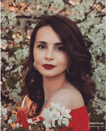 a woman in a red off the shoulder top is surrounded by flowers