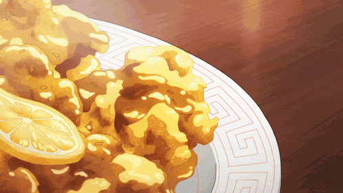 a plate of fried food with a lemon slice on top