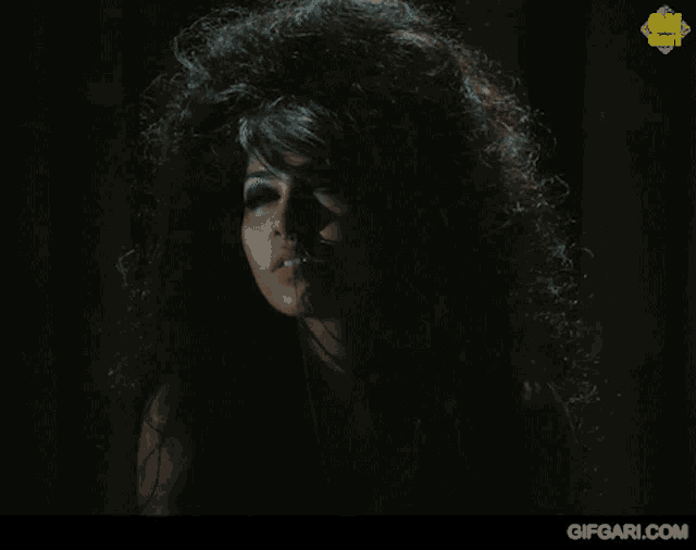 a close up of a woman 's face with a gifgari.com watermark