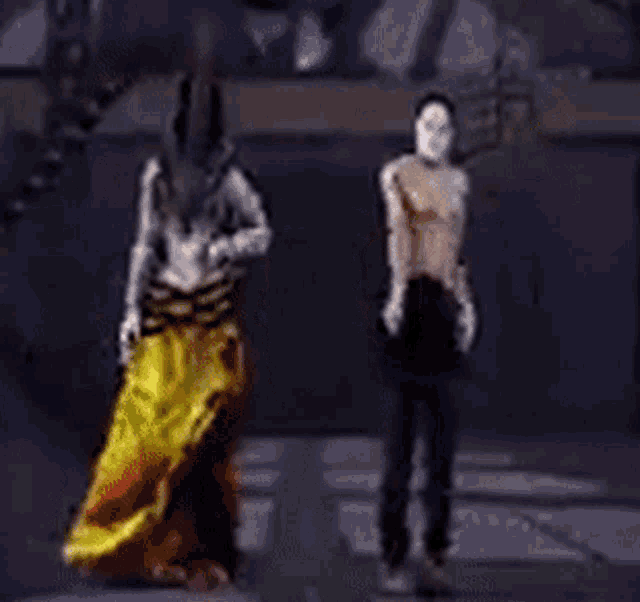 a man in a mask is standing next to a man in a mask .