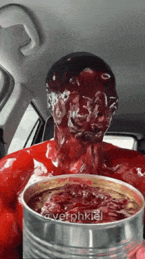 a person in a car with a can of jelly on their face