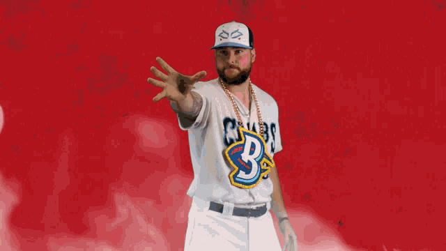 a man wearing a baseball uniform with the letter b on the front