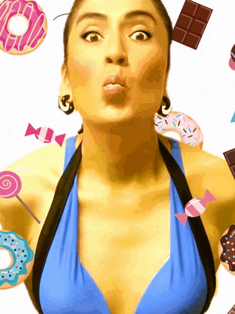 a woman in a blue top is surrounded by candy