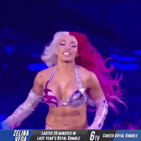 a female wrestler with pink and white hair is on a stage