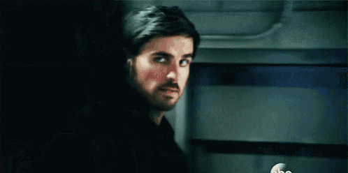a close up of a man with a beard wearing a black leather jacket .