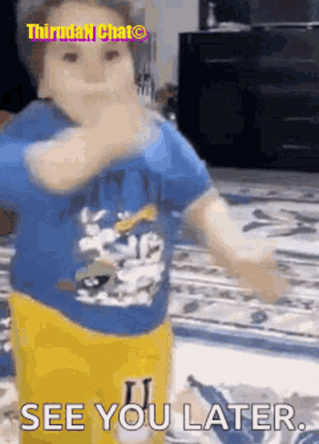 a little boy in a blue shirt and yellow pants is dancing and says see you later