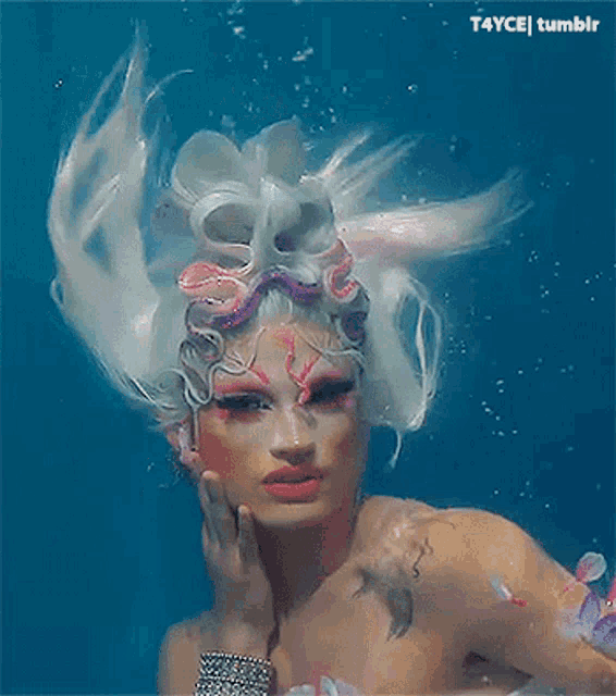 a picture of a drag queen in the water with t4ycej tumblr written above her