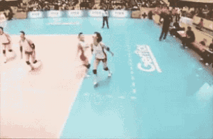 a volleyball game is being played on a court that has a sign that says ' gentle ' on it