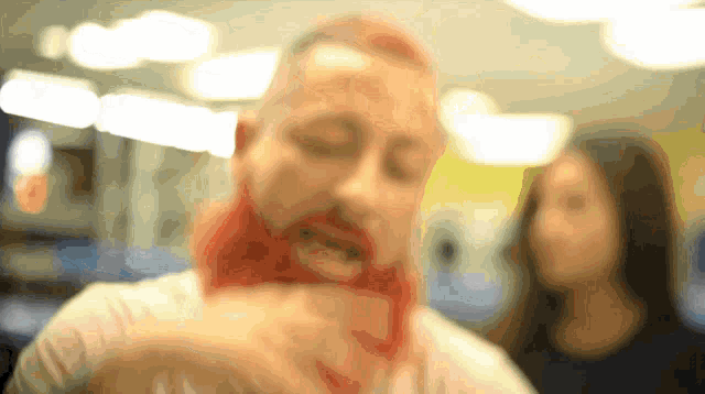 a blurry picture of a man with red hair and a red beard