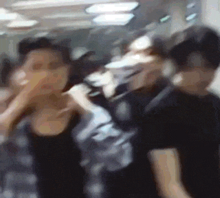 a blurry picture of a group of people standing next to each other .
