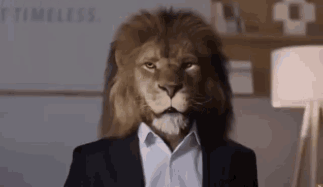 a lion is wearing a suit and a white shirt .