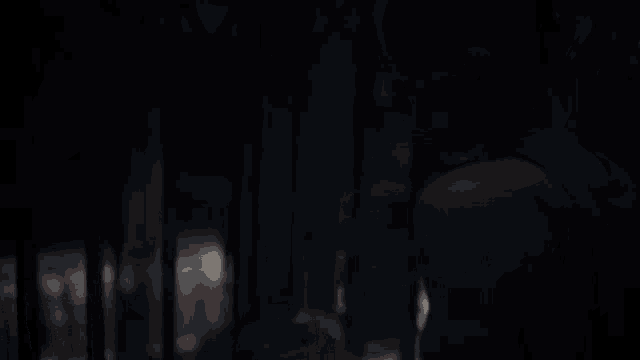 two women are standing in a dark room looking at each other