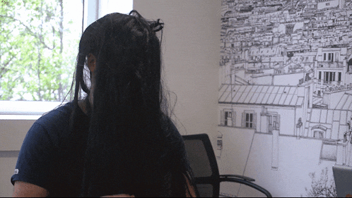 a woman 's head is visible in front of a drawing of buildings