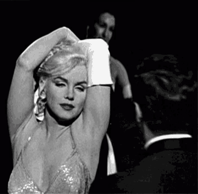 a black and white photo of a woman in a sequined top