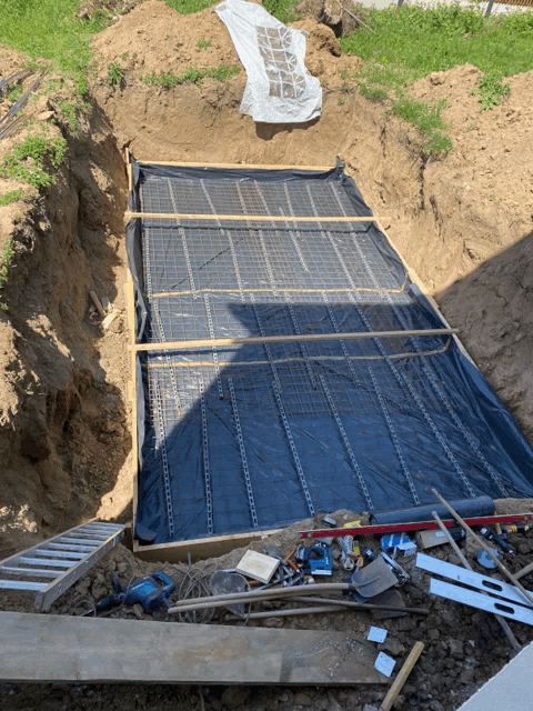 a concrete slab is being built in the dirt