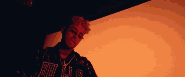 a man wearing a jacket that says bulls on the front