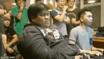 a group of young men are playing video games in a room .