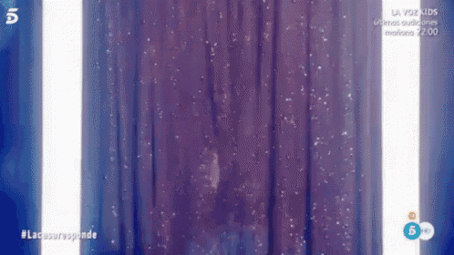 a purple curtain with a white light coming through it