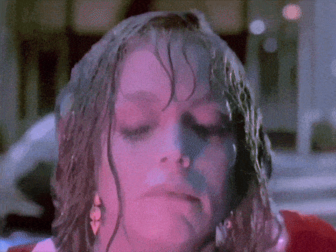 a close up of a woman 's face with a pink background