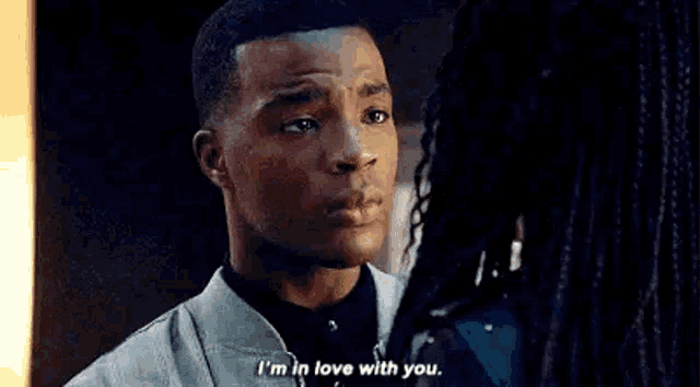 a man and woman are looking at each other and the man is saying `` i 'm in love with you '' .