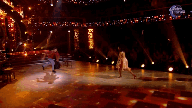 a man and woman are dancing on a stage with dancing brasil written on the bottom