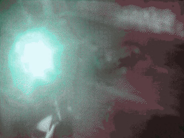 a green light is shining on a dark purple background