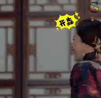 a woman with a yellow sticker on her head with chinese characters on it