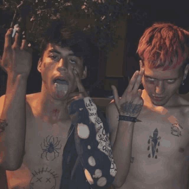 a shirtless man with a spider tattoo on his chest is giving the middle finger to another shirtless man