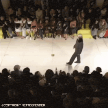 a blurred image of a crowd of people with the words copyright nettdefender on the bottom