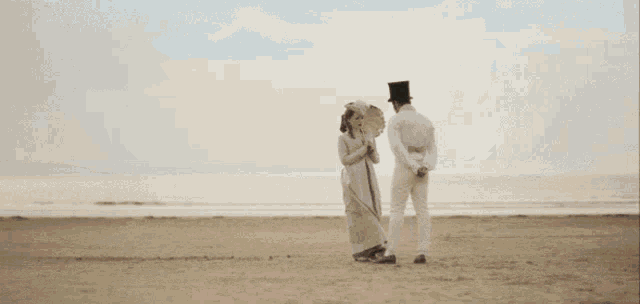 a woman wearing a hat and an umbrella is standing next to a man