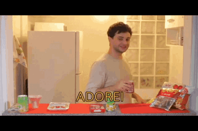 a man standing in front of a refrigerator with the word adorei on the top