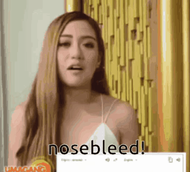 a woman in a white top says nosebleed