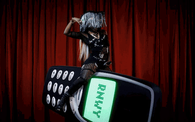 a woman is sitting on a phone that says rhhh