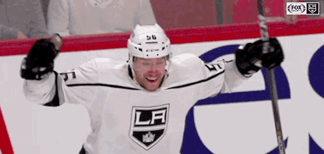 a hockey player wearing a jersey that says la
