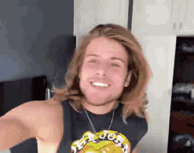 a man with long hair is wearing a shirt that says job