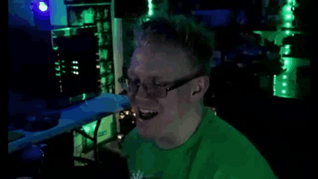 a man wearing glasses and a green shirt that says intel