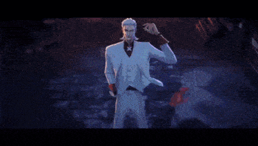 a man in a white suit is surrounded by people