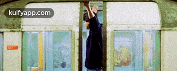 a man is getting on a train and the website kulfyapp.com is displayed