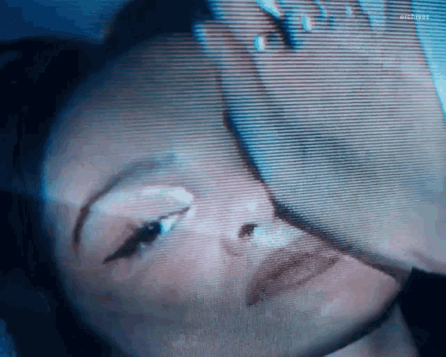 a close up of a woman 's face with a blurry background .